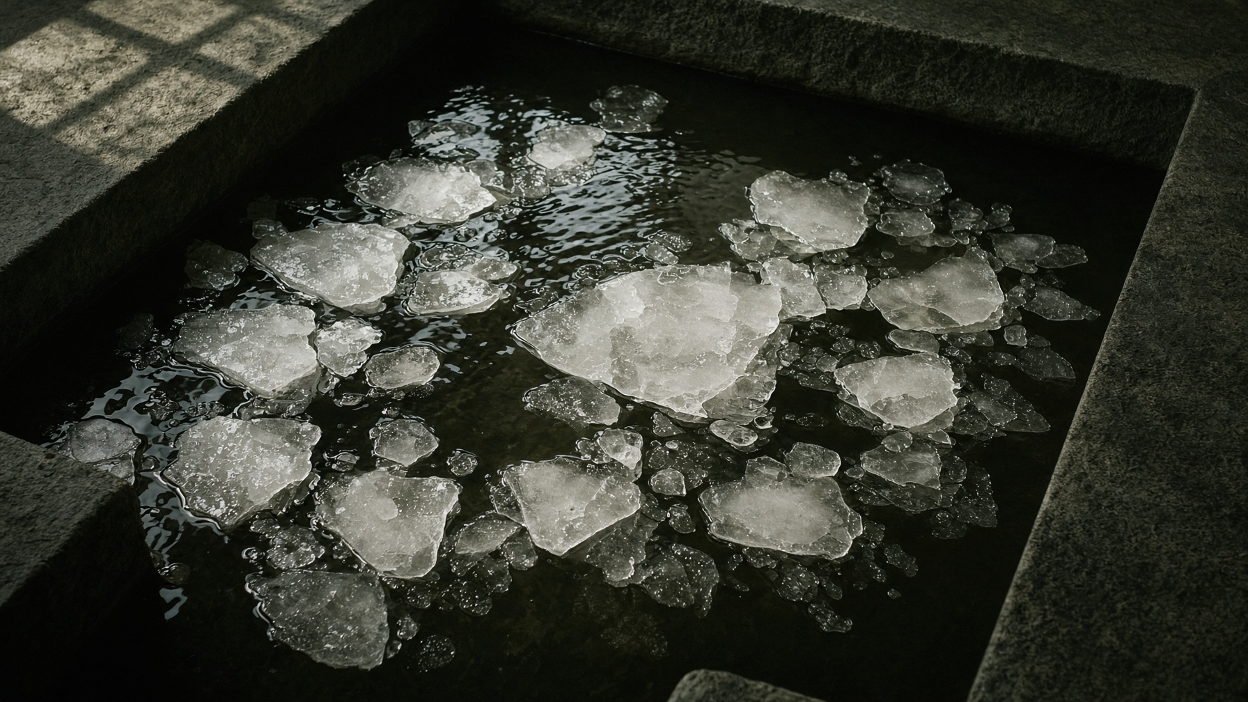 Ice in a dark cold plunge